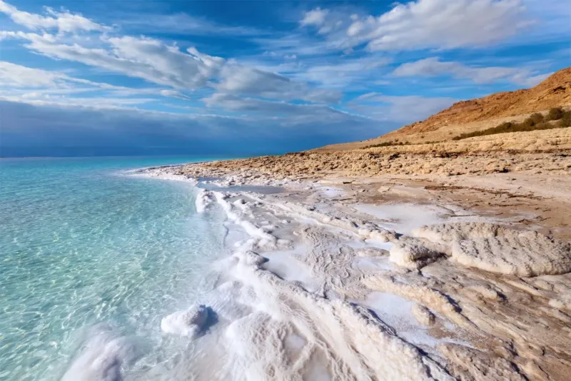 Floating in the Dead Sea featured in the 23 Days Middle East Travel Package: Morocco, Egypt, Jordan, and Dubai.